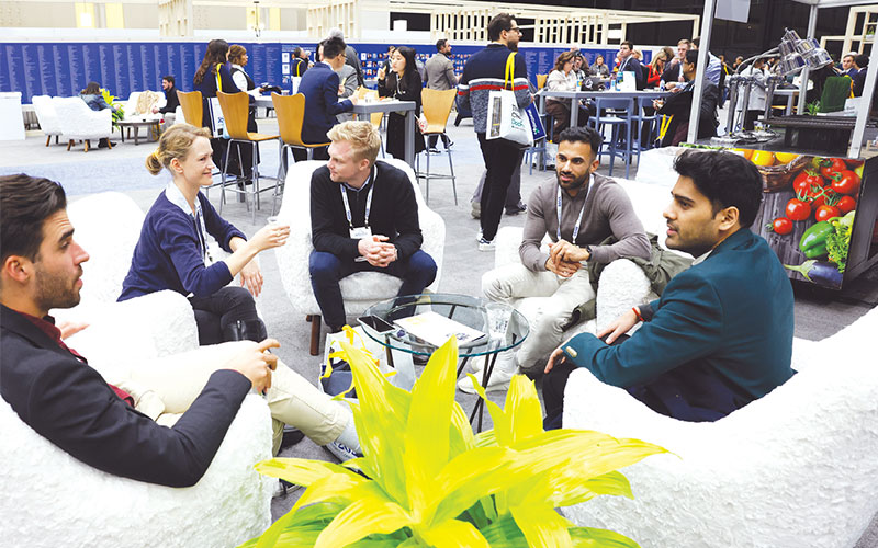 A group of men and women of various ethnicities sit around a small table at the RSNA annual meeting.